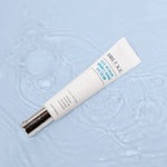 Brucke eye cream tube on a textured light blue background