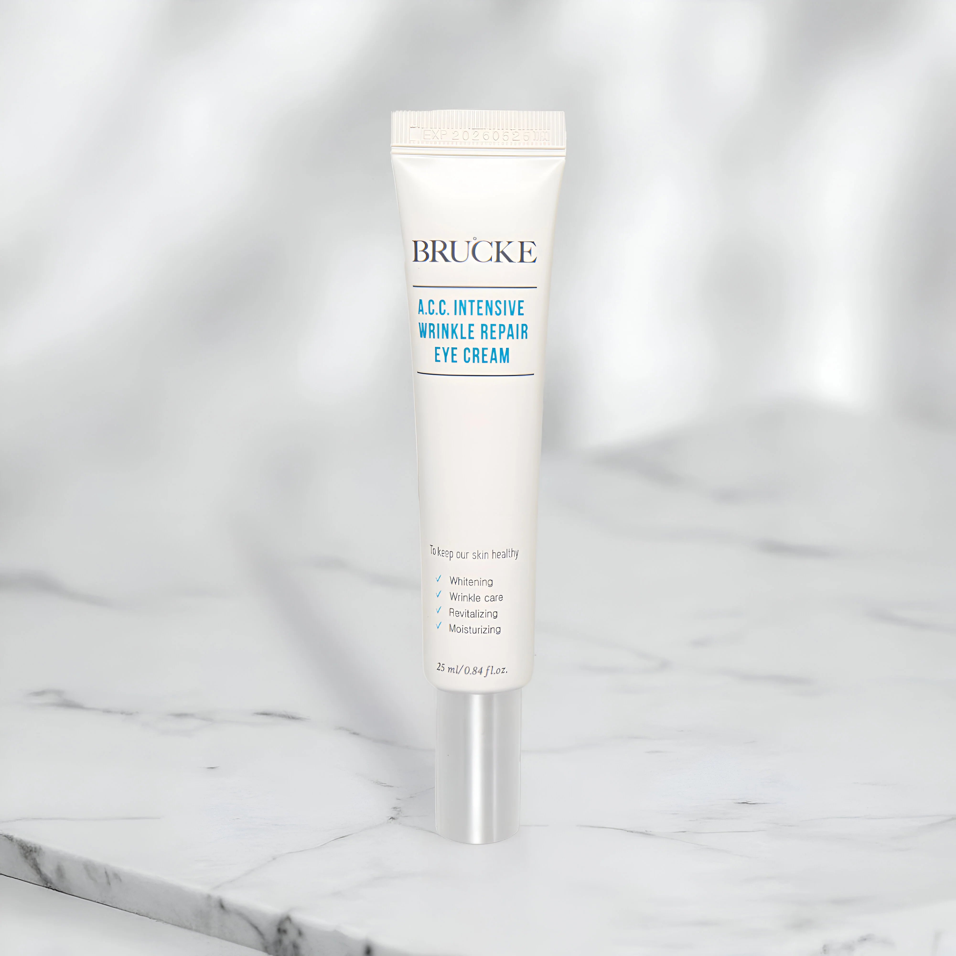 Brucke A.C.C. Intensive Wrinkle Repair Eye Cream tube on a marble surface with a white background