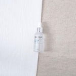 Skincare bottle labeled 'Brucke' on a neutral background