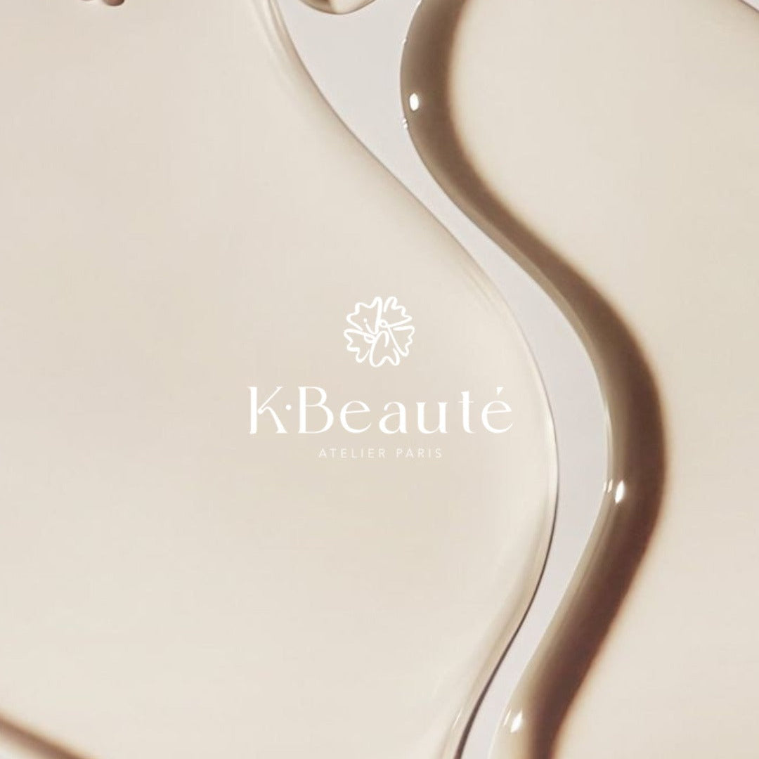 KBeauté logo with a droplet of liquid on a beige background