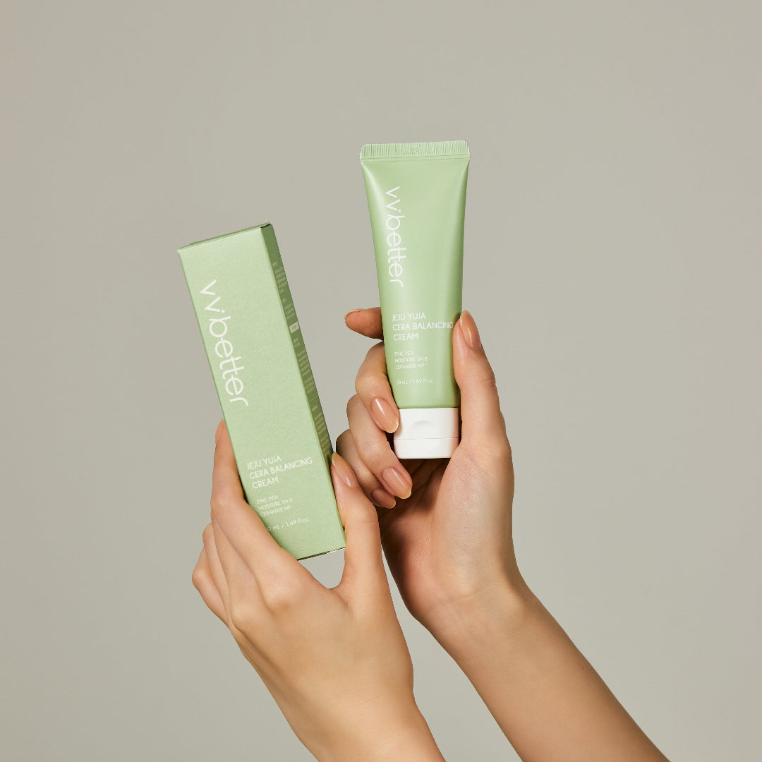 Two green skincare products held by hands against a neutral background